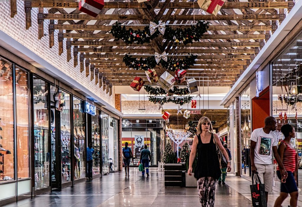 Holiday budget, shopping mall at Christmas, woman shopping