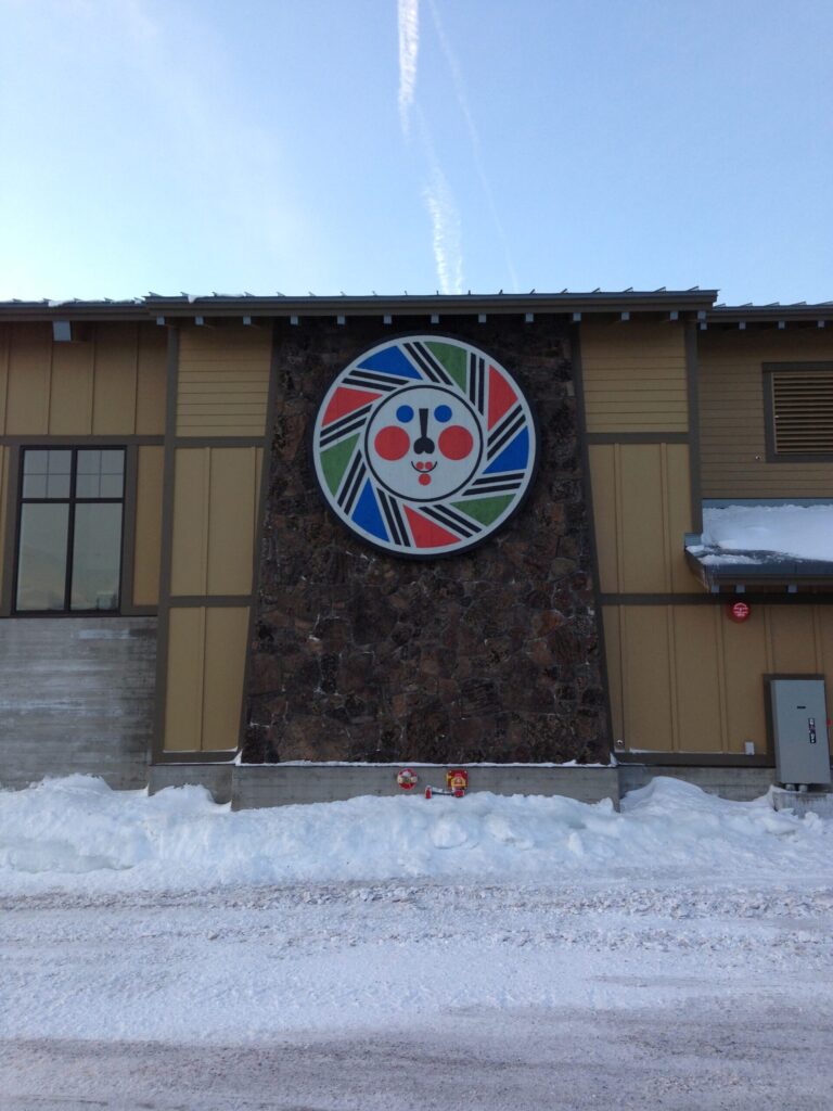 Mt Bachelor Main Lodge Logo Mt. Bachelor logo on a building at the main base area